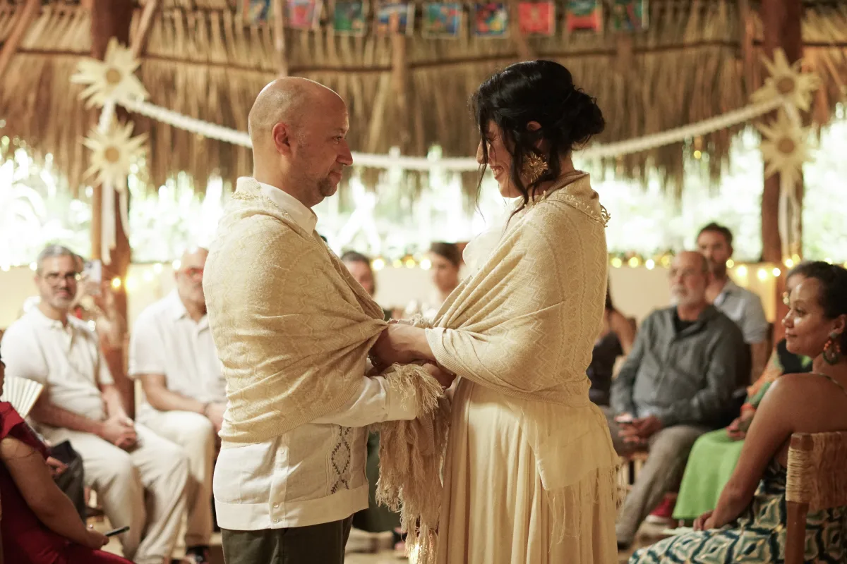 Bride and groom wrapped together during the ceremony in the jungle temple