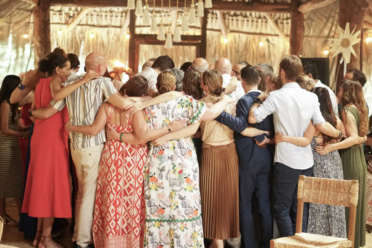 The whole tribe in a group embrace inside the temple at the end of the ceremony