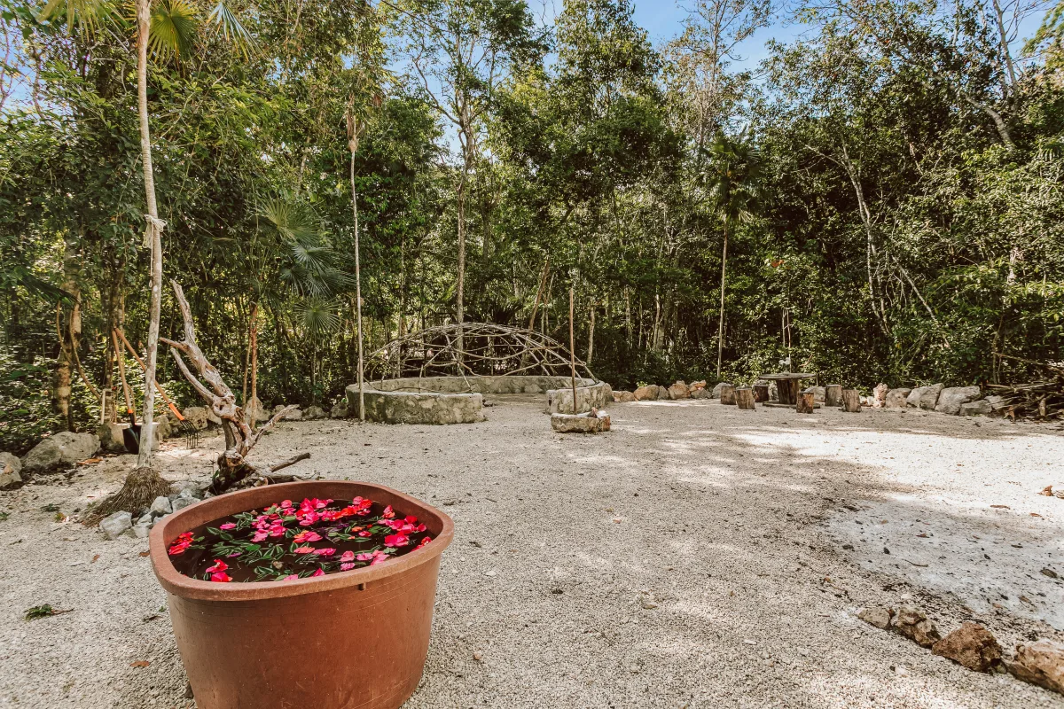 Traditional temazcal ceremony structure at Casa Arkaana — stone and earth sweat lodge in the jungle
